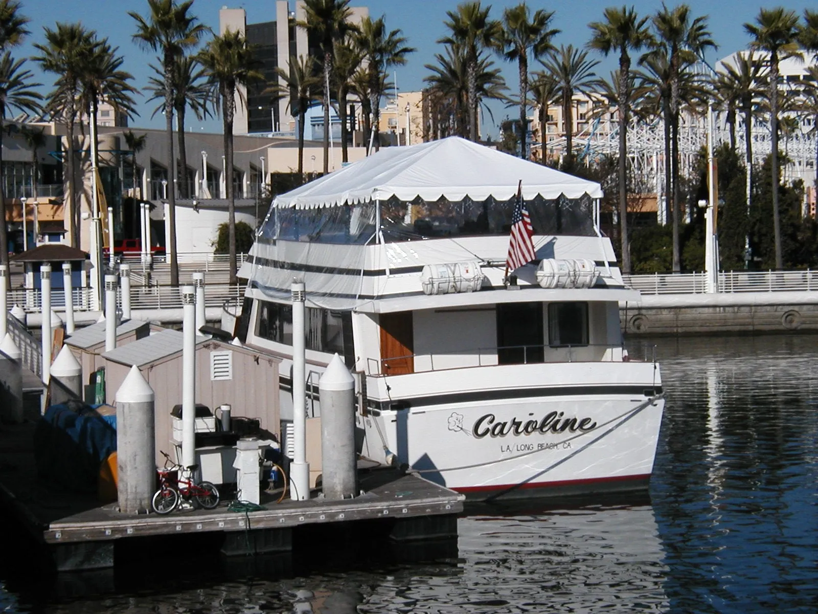A custom white canopy top with a scalloped valance on a yacht deck.