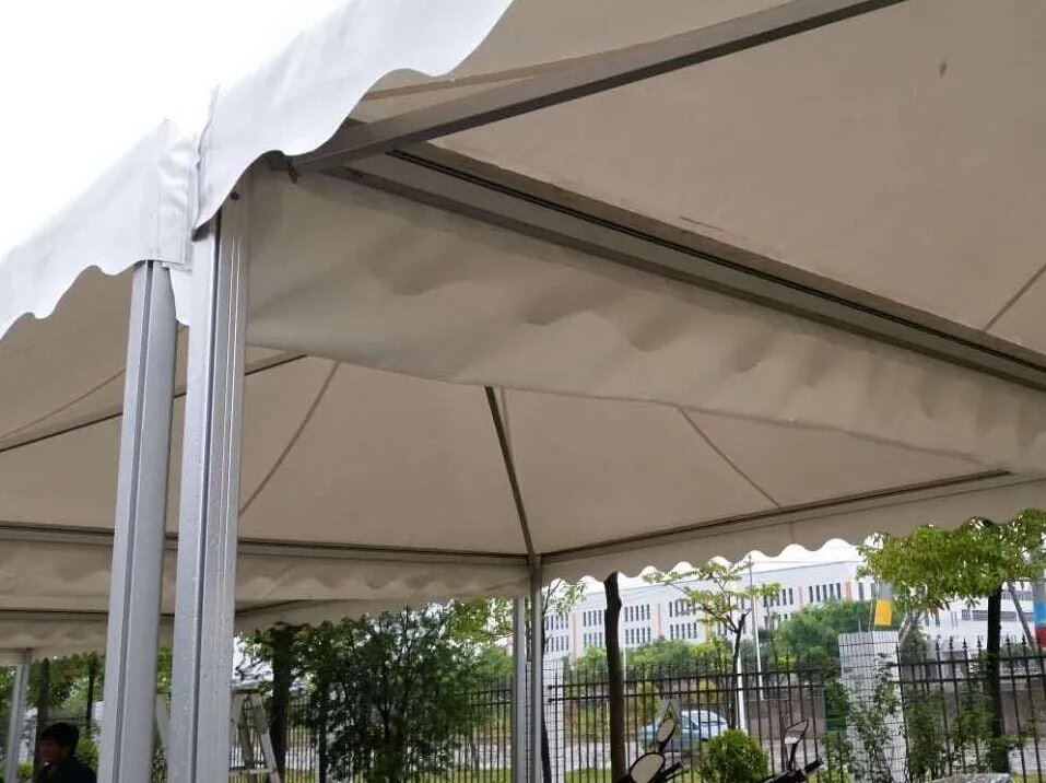 A rain gutter between joined frame tents.